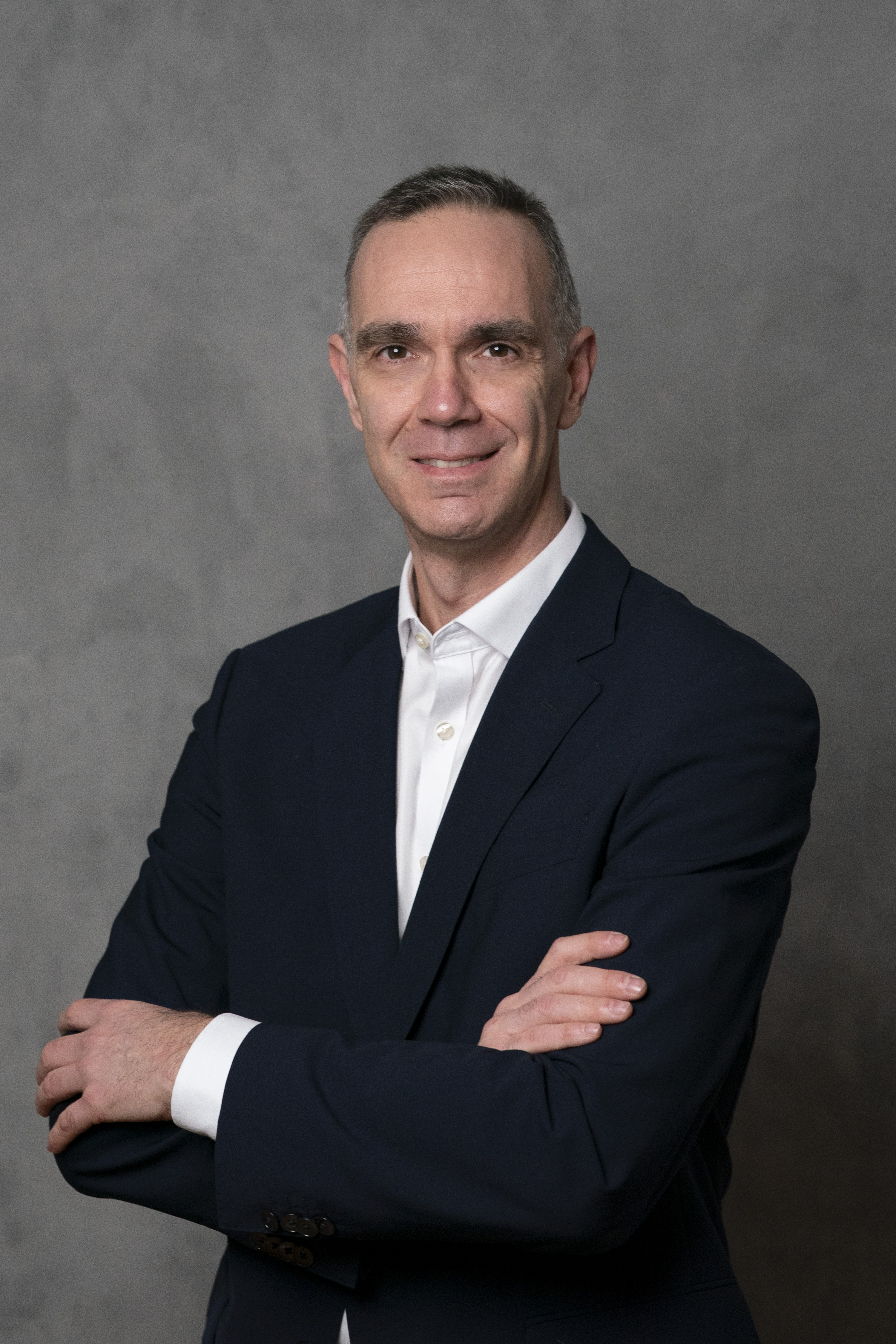 Man in suit with his arms crossed.